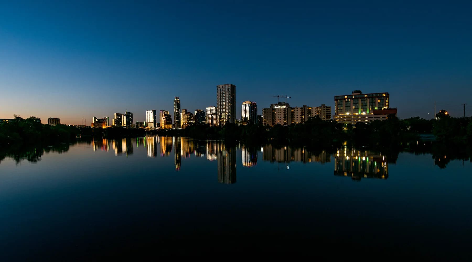 Austin skyline reflected in Lady Bird Lake at dusk