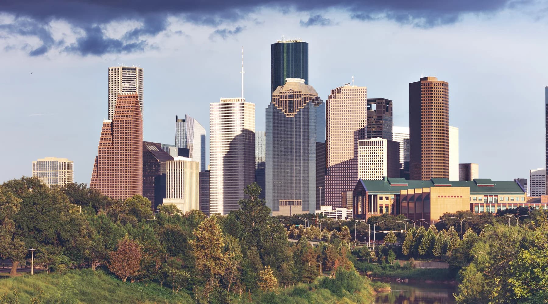 Downtown Houston skyline rising above green parkland