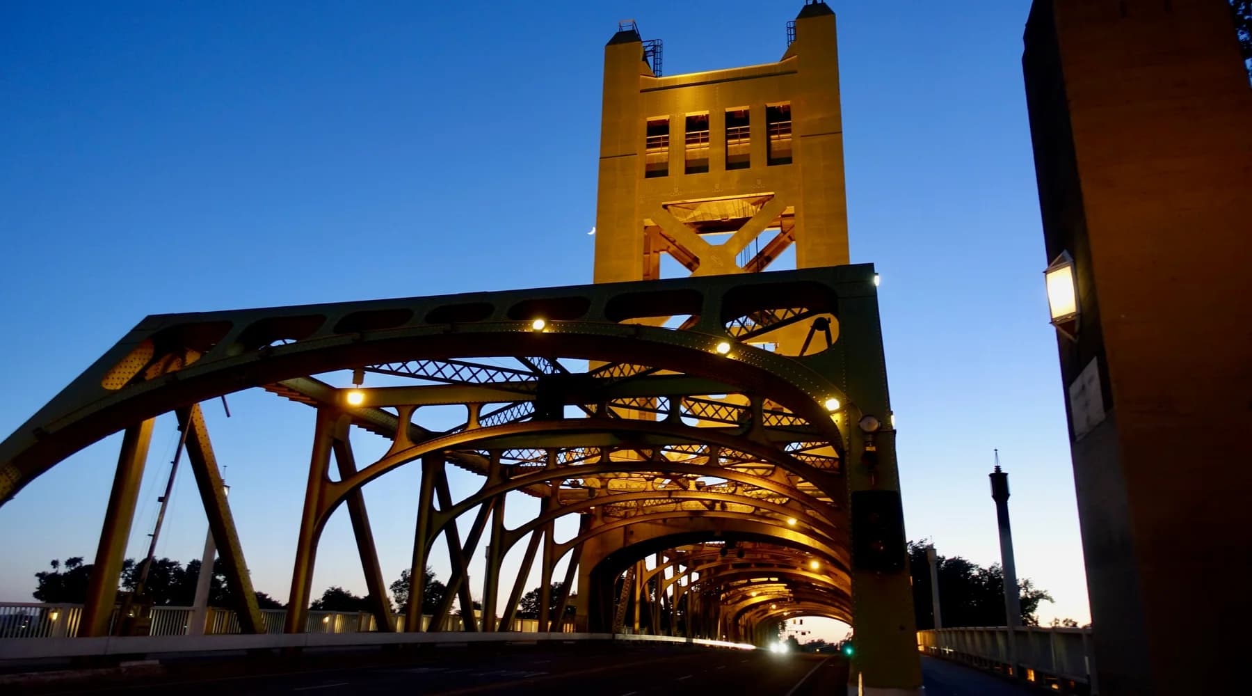 Golden steel spans of Tower Bridge in Sacramento at dusk