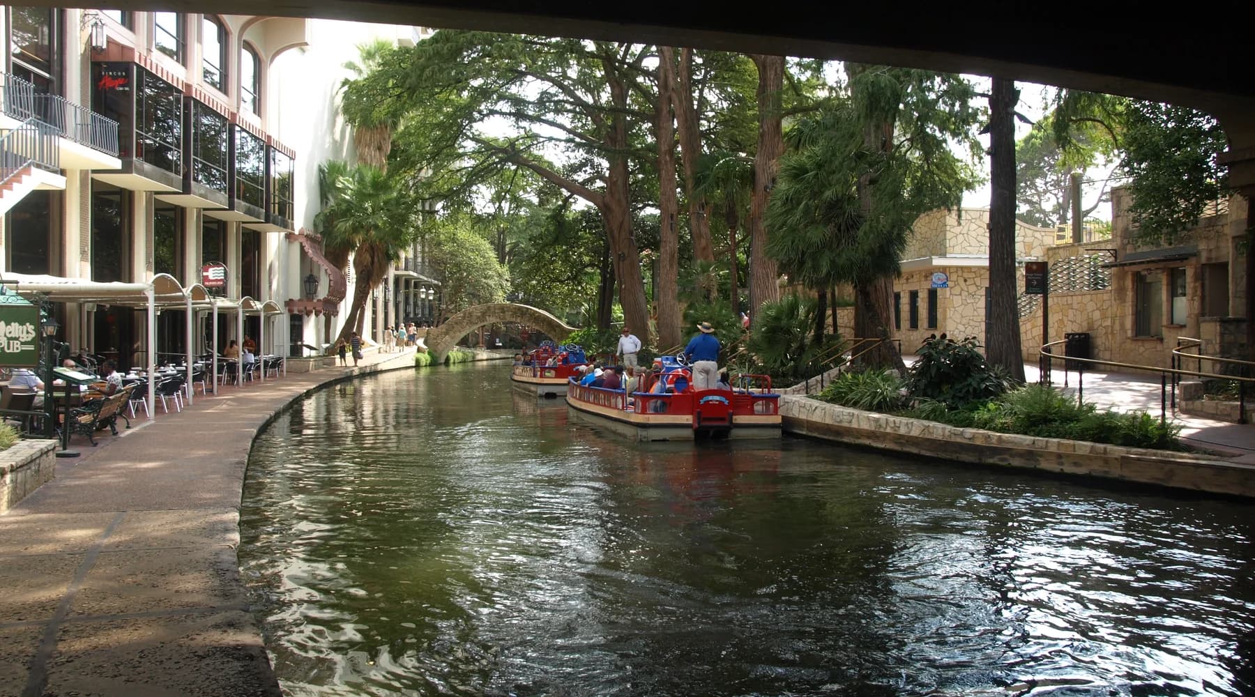 Boats and stone walkways along the San Antonio River Walk