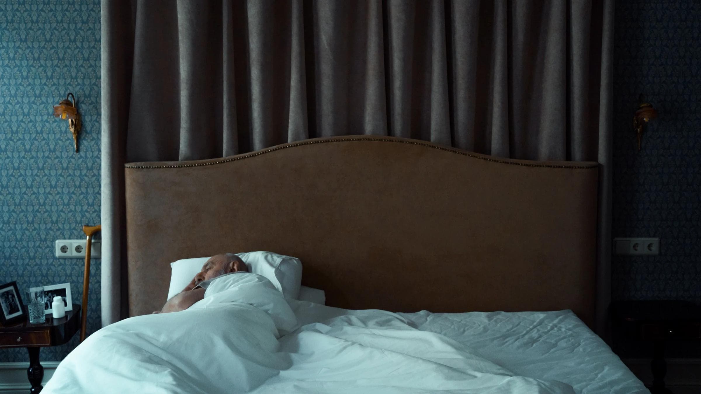 A serene bedroom with a man sleeping, evoking a sense of tranquility and comfort.