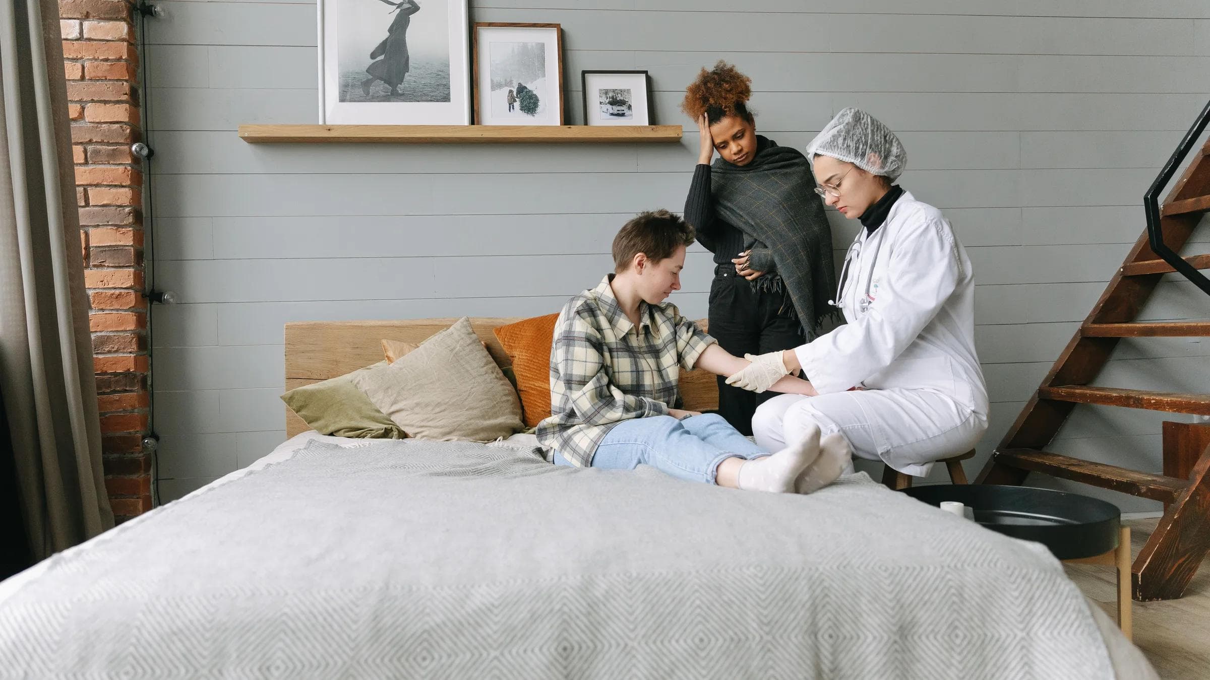 A doctor offers supportive care to a patient in a cozy bedroom setting, fostering recovery.