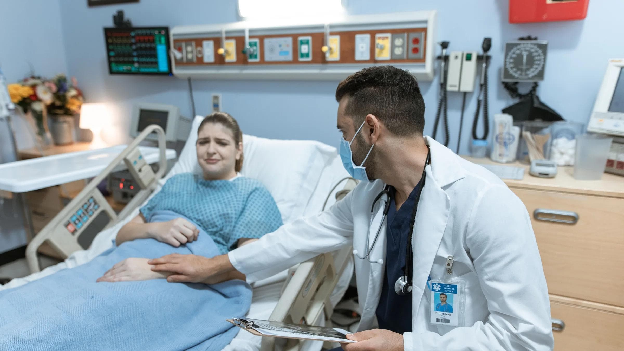 A doctor comforts an ill patient in a hospital room, embodying care and compassion.