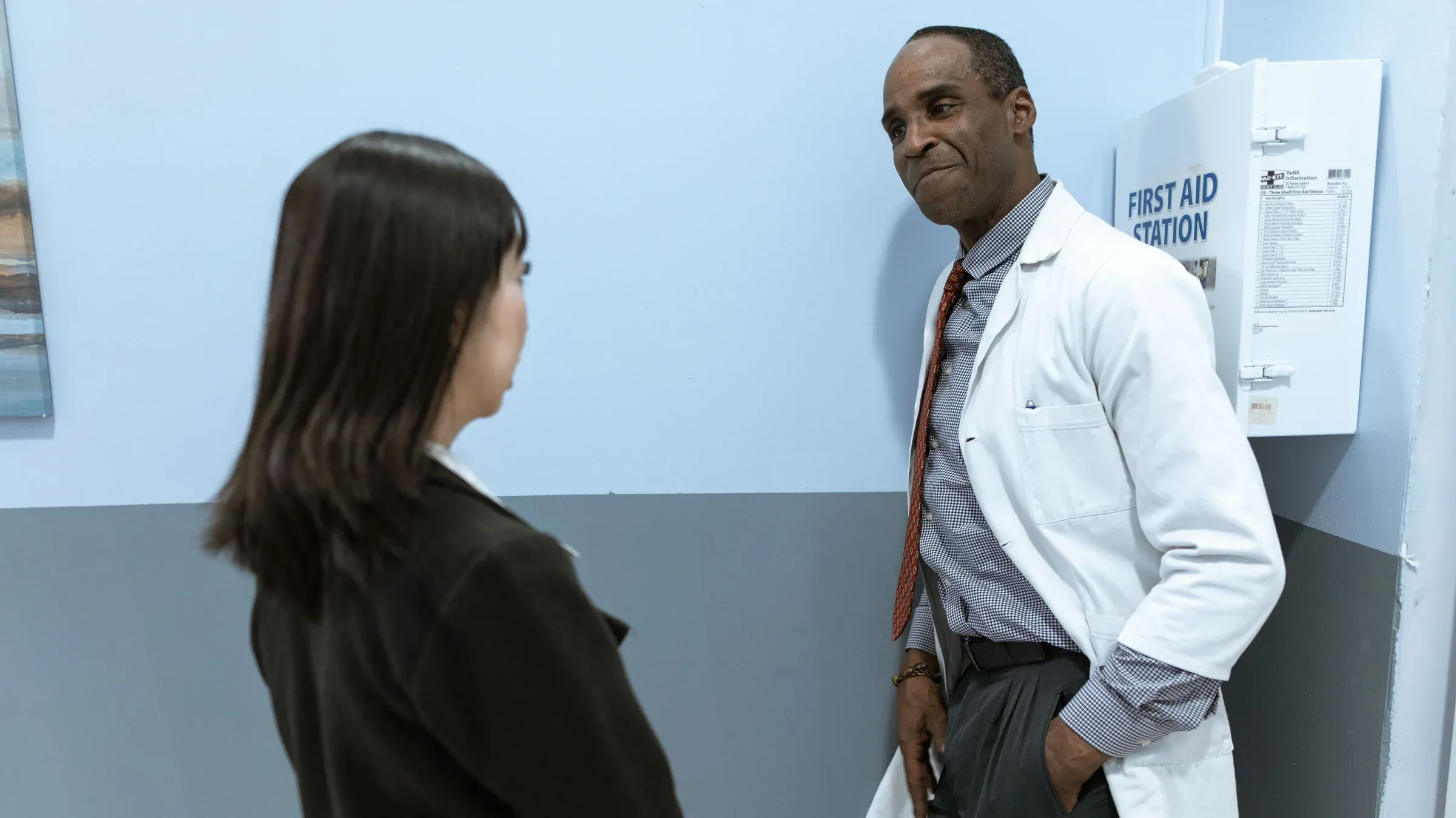 A medical professional converses with a patient in a clinical setting, fostering a comforting environment.