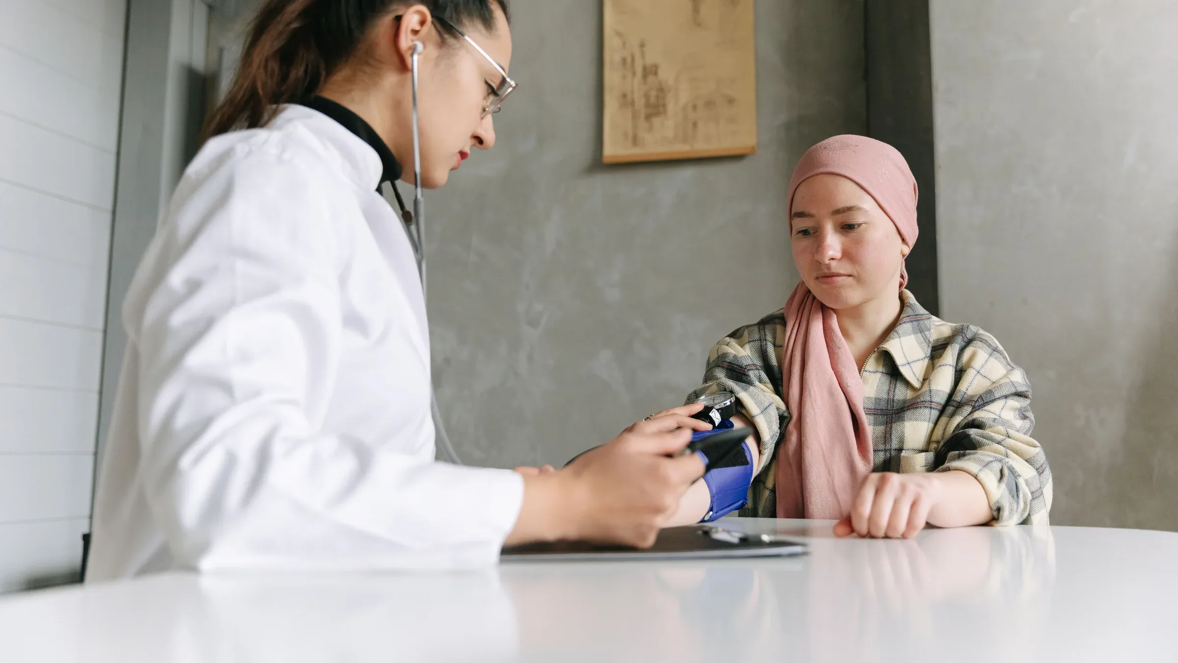 A medical professional checks a patient's blood pressure, depicting a caring healthcare environment.
