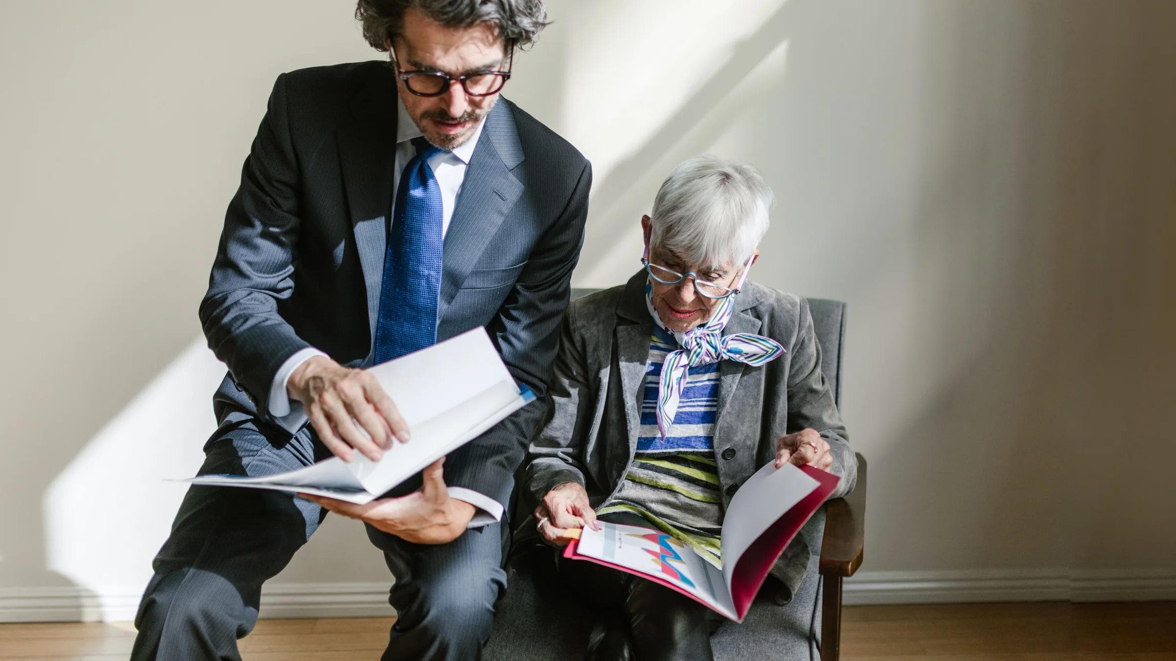 Business professionals reviewing documents in a bright office setting.
