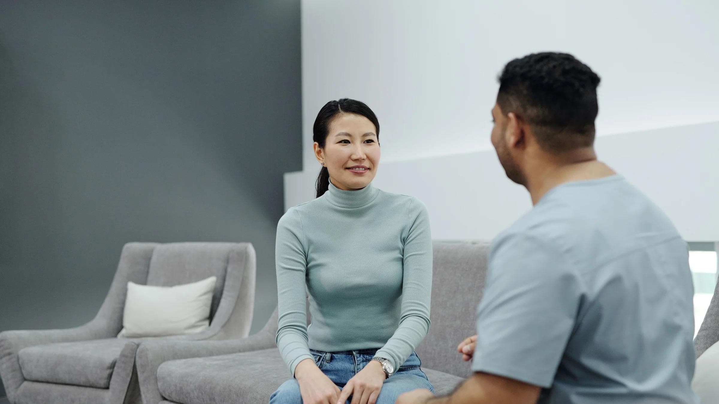A doctor and patient having a friendly conversation in a modern clinic.