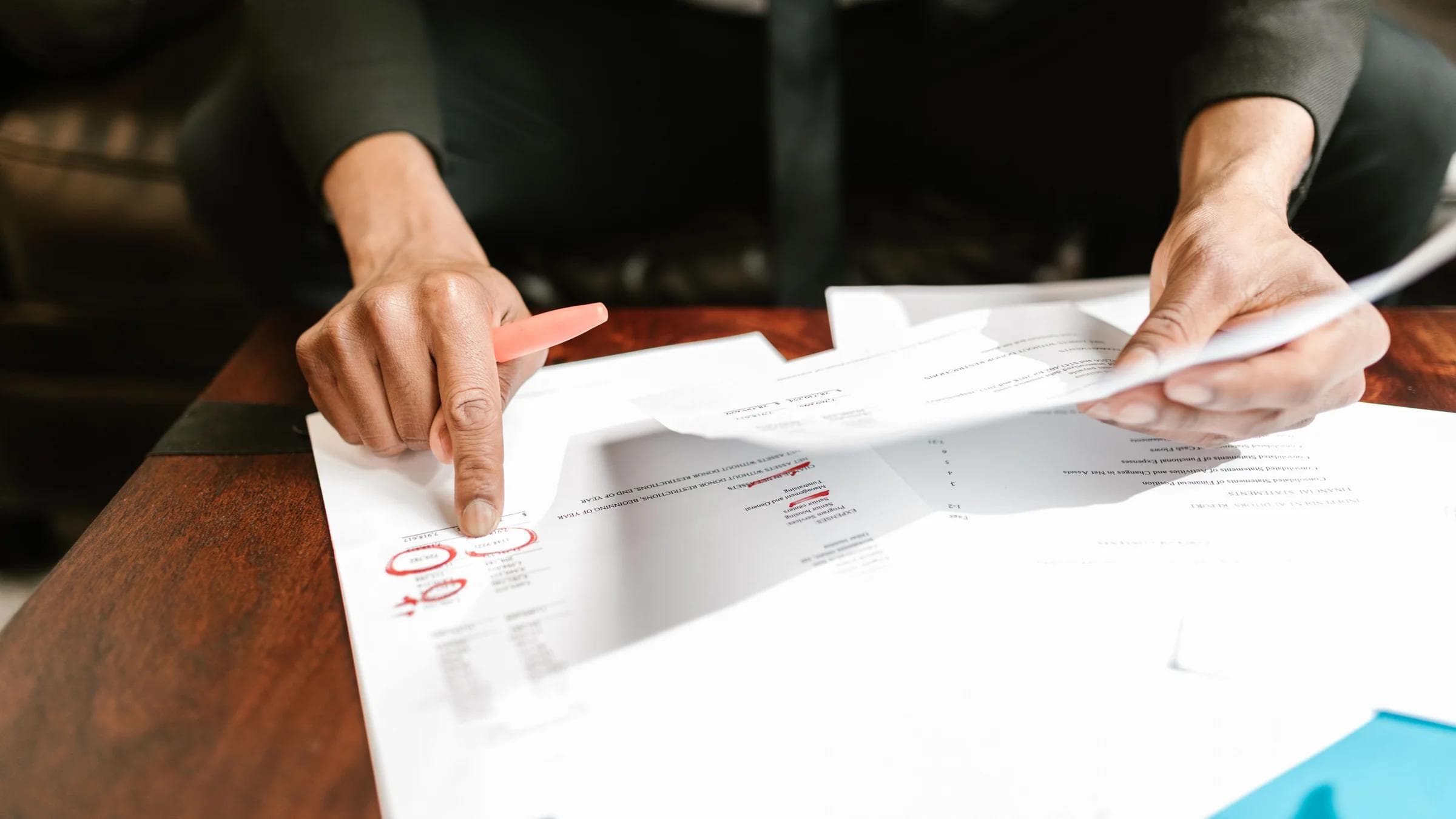 A businessman analyzing financial documents with important data and figures on a desk, ideal for business analytics and accounting themes.